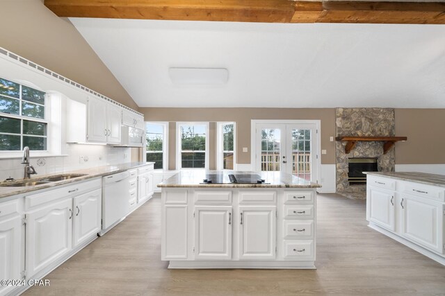 kitchen featuring wine cooler, white cabinetry, black electric stovetop, and a kitchen island