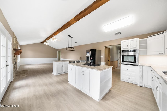 kitchen with white cabinets, decorative light fixtures, a center island, and stainless steel appliances