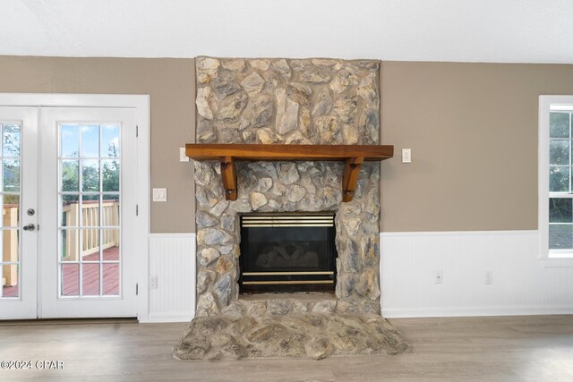 details with hardwood / wood-style floors, a fireplace, and french doors