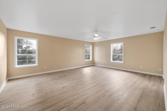 empty room featuring ceiling fan and light wood-type flooring