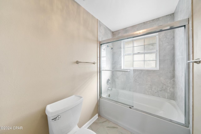 bathroom featuring shower / bath combination with glass door and toilet