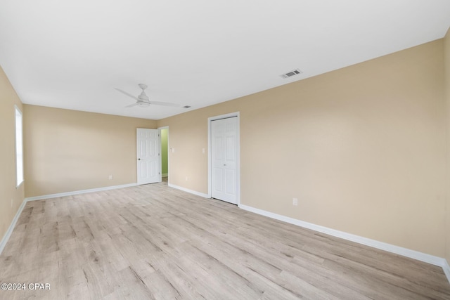 empty room with ceiling fan and light wood-type flooring