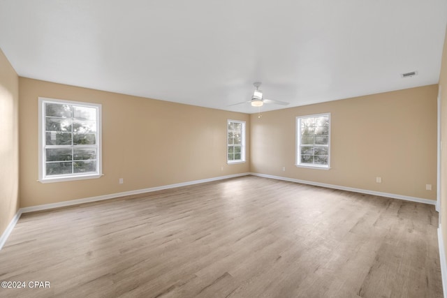 spare room with light hardwood / wood-style flooring and ceiling fan