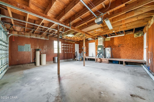 garage with electric panel, electric water heater, and a garage door opener