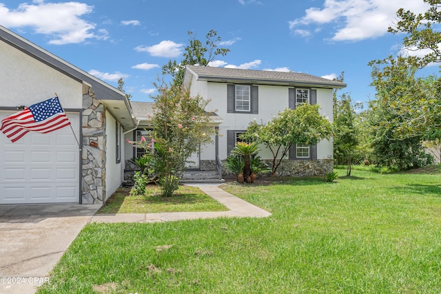 view of front of property with a garage and a front yard