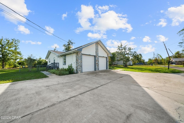 view of side of home with a garage and a lawn