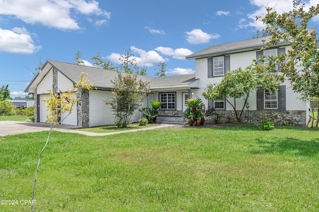 view of front of home featuring a front yard and a garage