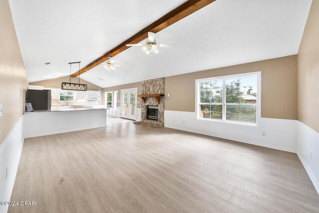 kitchen featuring white cabinetry, kitchen peninsula, pendant lighting, stainless steel appliances, and light hardwood / wood-style floors