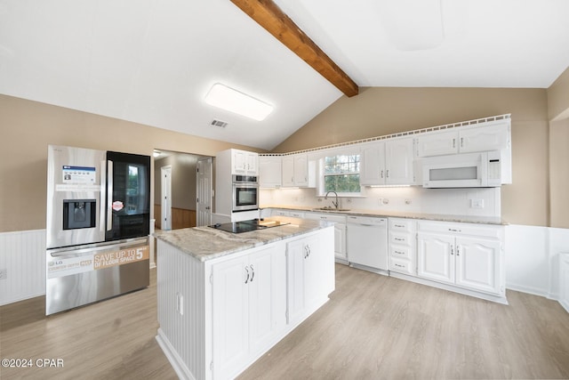 kitchen featuring vaulted ceiling with beams, white cabinets, stainless steel appliances, and a kitchen island