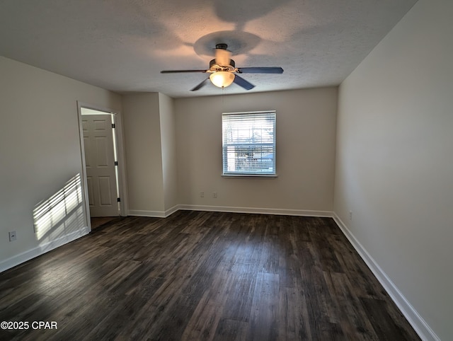 unfurnished room with a textured ceiling, ceiling fan, and dark wood-type flooring