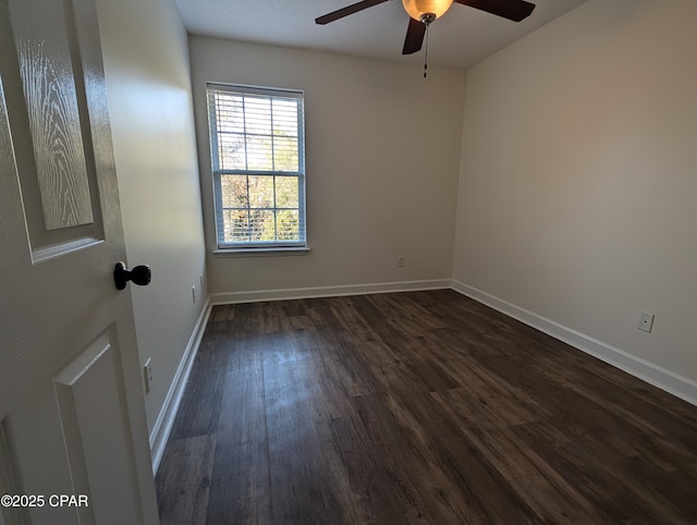 empty room featuring dark hardwood / wood-style floors and ceiling fan