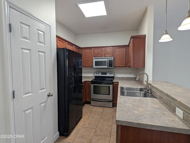 kitchen featuring black fridge, stainless steel range with electric stovetop, sink, light tile patterned floors, and hanging light fixtures