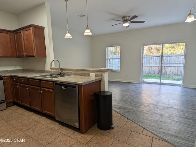 kitchen with kitchen peninsula, stainless steel dishwasher, ceiling fan, sink, and decorative light fixtures