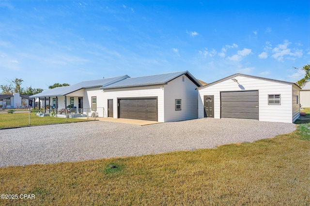 410 W 4th St, Lynn Haven, FL 32444 - view of front facade with a front yard, driveway, an attached garage, and an outdoor structure