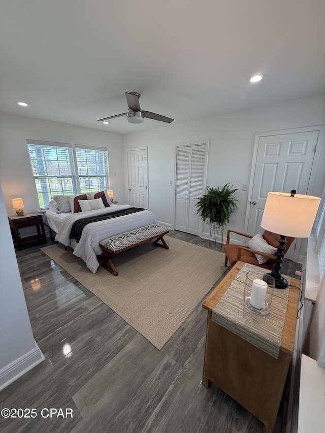 410 W 4th St, Lynn Haven, FL 32444 - bedroom with two closets, dark wood-style floors, ceiling fan, recessed lighting, and baseboards