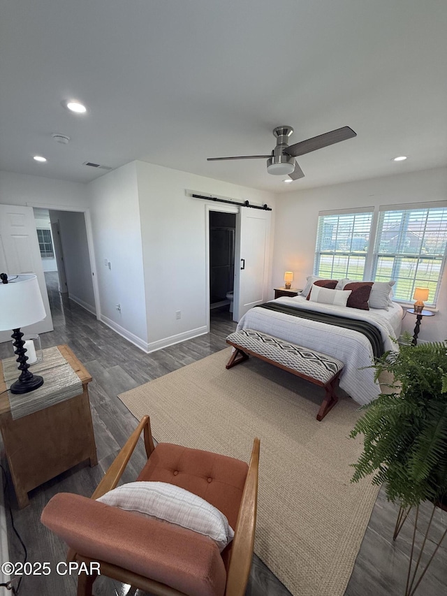 410 W 4th St, Lynn Haven, FL 32444 - bedroom with a barn door, recessed lighting, baseboards, wood finished floors, and ceiling fan