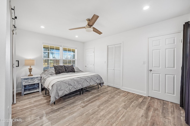 bedroom featuring light wood-type flooring and ceiling fan