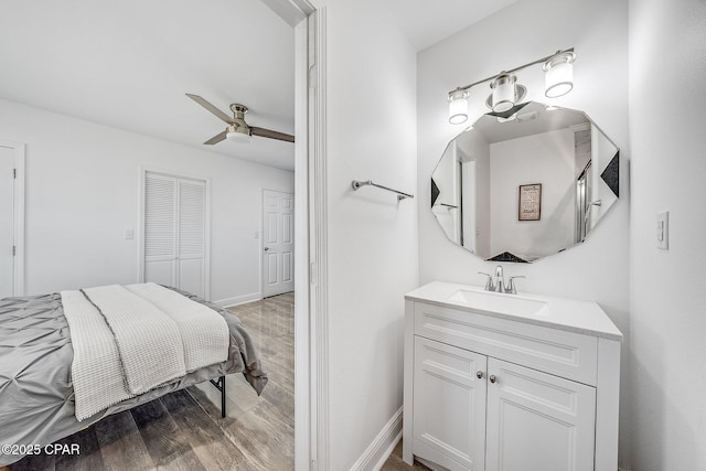 bathroom with ceiling fan, wood-type flooring, and vanity