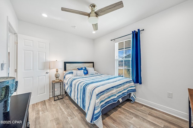 bedroom with hardwood / wood-style floors and ceiling fan