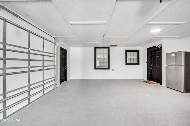 garage featuring stainless steel fridge