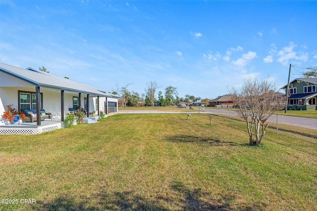 view of yard featuring covered porch