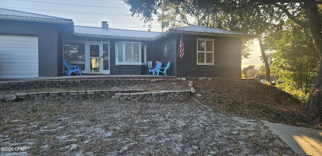 rear view of house with a patio and a garage