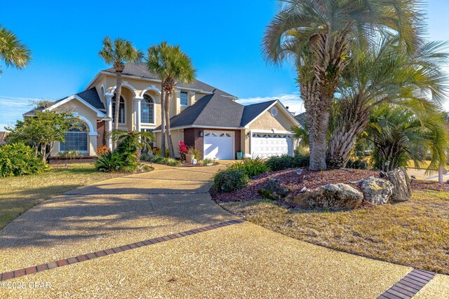 view of front of house featuring a garage and a front lawn