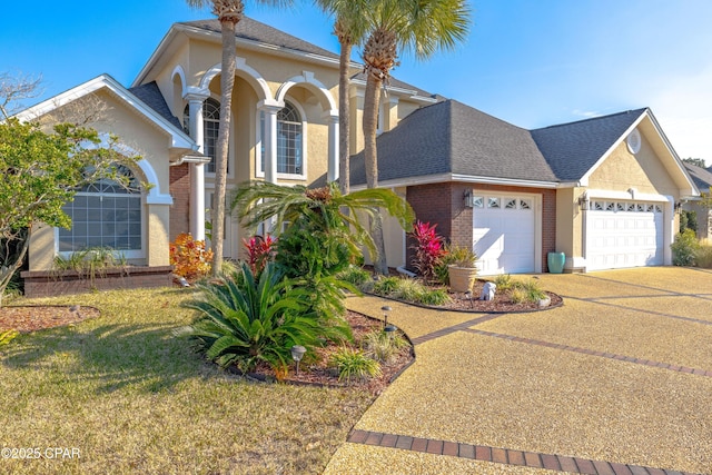 view of front of property with a garage and a front yard