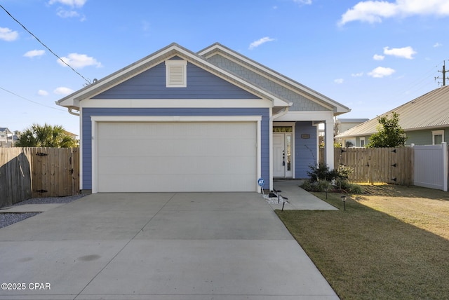 view of front of property featuring a garage and a front lawn