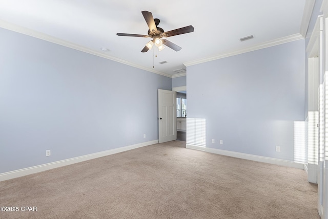 carpeted spare room featuring ceiling fan and ornamental molding