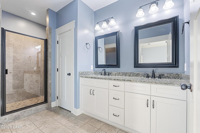 bathroom with tile patterned flooring, vanity, and an enclosed shower