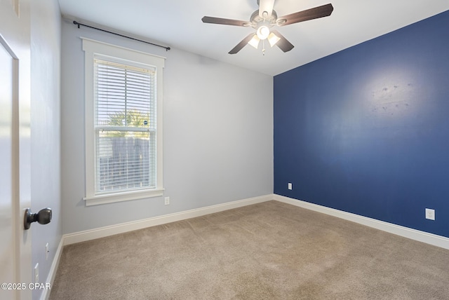 carpeted empty room featuring ceiling fan