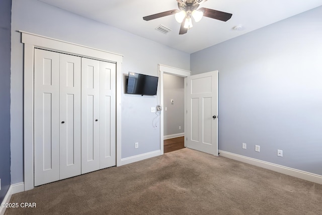 unfurnished bedroom with ceiling fan, a closet, and carpet floors