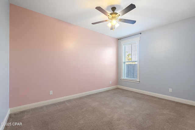 unfurnished room with ceiling fan and light carpet