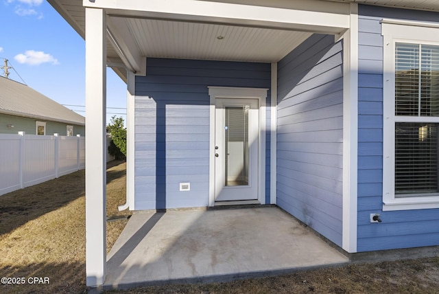 view of exterior entry featuring a patio area