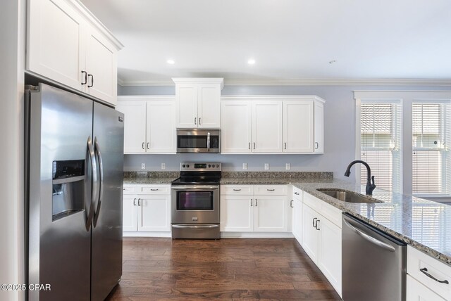 kitchen with white cabinets, sink, dark hardwood / wood-style floors, stone countertops, and stainless steel appliances