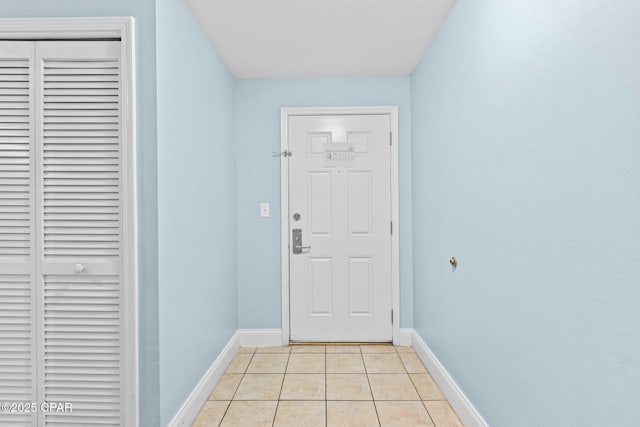 doorway to outside featuring light tile patterned flooring