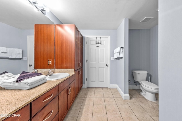 bathroom featuring tile patterned floors, vanity, and toilet