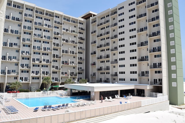 view of building exterior with a community pool