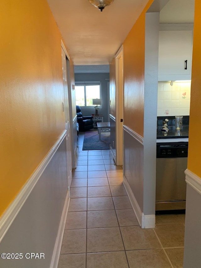 hall featuring light tile patterned flooring