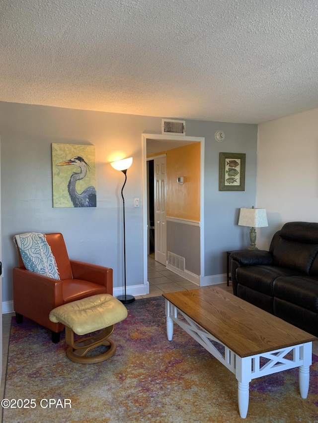 living room with light tile patterned floors and a textured ceiling