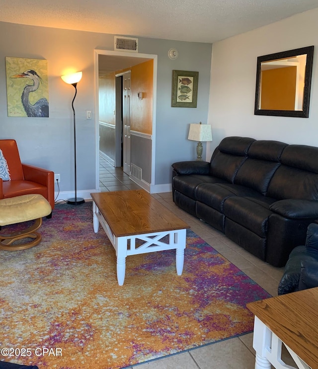 living room with light tile patterned flooring and a textured ceiling