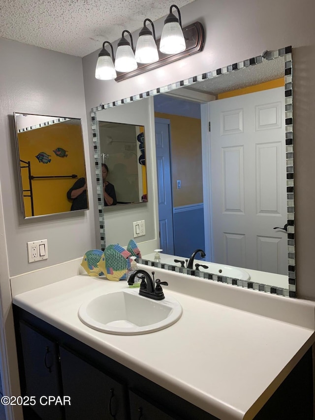 bathroom with vanity and a textured ceiling