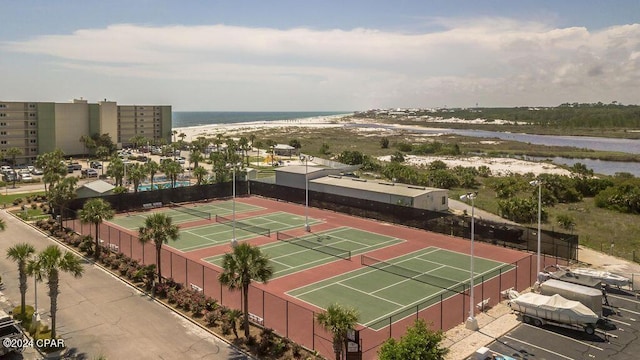 view of tennis court featuring a water view