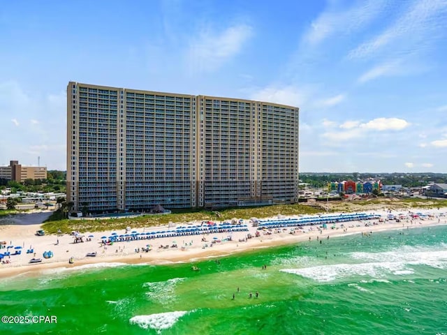 bird's eye view featuring a view of the beach and a water view