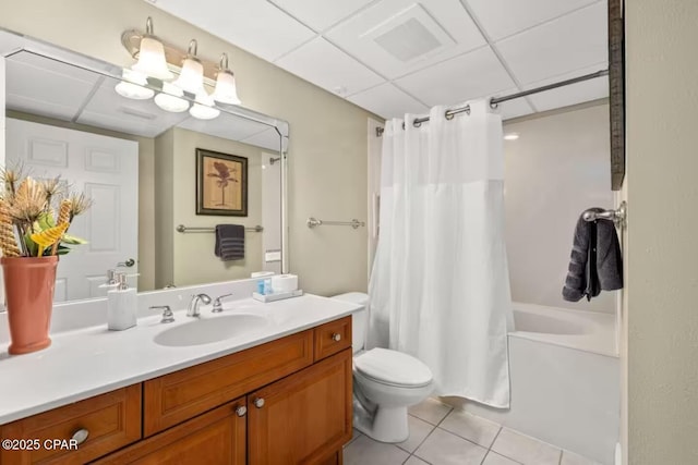 full bathroom with shower / bath combo, tile patterned flooring, toilet, a paneled ceiling, and vanity