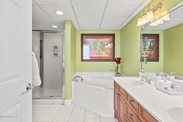 bathroom with tile patterned flooring, a drop ceiling, vanity, and independent shower and bath