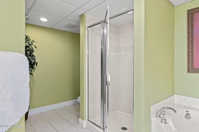 bathroom with tile patterned floors, a paneled ceiling, separate shower and tub, and toilet