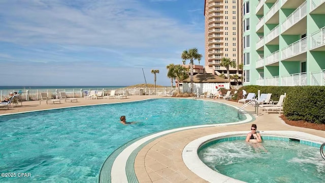 view of swimming pool with a water view