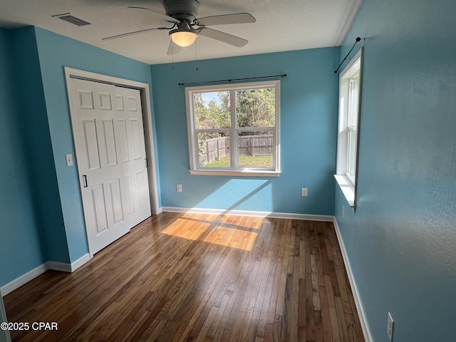 spare room with ceiling fan and wood-type flooring